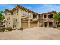 The exterior view of a home with a private two-car garage, balcony, and desert landscaping at 19700 N 76Th St # 2101, Scottsdale, AZ 85255