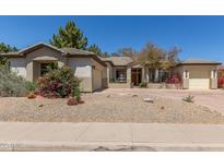 Charming single-story home with a well-maintained yard, desert landscaping, and a circular driveway at 2060 E Prescott Pl, Chandler, AZ 85249