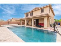 Exterior of home showcasing a large swimming pool, covered patio and second story view at 2425 E Flintlock Dr, Gilbert, AZ 85298
