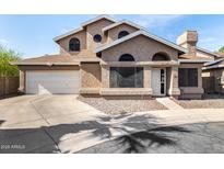 Charming two-story home featuring unique architectural details and a two-car garage at 4212 W Jason Dr, Glendale, AZ 85308
