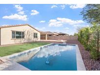 Sparkling pool is surrounded by desert landscaping, green grass and ample space for outdoor enjoyment at 4360 N 186Th Ln, Goodyear, AZ 85395