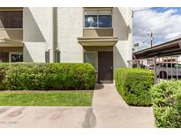 Inviting front entrance with well-maintained landscaping and a charming, painted brick facade at 7740 E Heatherbrae Ave # 13, Scottsdale, AZ 85251
