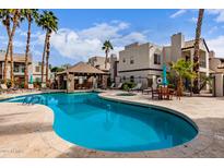 Community pool with sun loungers and covered seating area, perfect for relaxation and entertainment at 14145 N 92Nd St # 1158, Scottsdale, AZ 85260