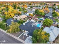 Aerial shot of a property with a sparkling pool and mature trees in a residential neighborhood at 1609 W State Ave, Phoenix, AZ 85021