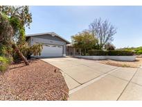 Charming single-story home featuring an attached two-car garage and mature landscaping at 1837 E Presidio Rd, Phoenix, AZ 85022