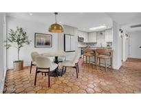 Charming dining area with a marble table, stylish chairs, and unique terracotta tiled flooring at 2814 N 62Nd N St, Scottsdale, AZ 85257