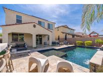 An inviting backyard pool features a sleek design and comfortable patio furniture for relaxation and entertainment at 31020 N 5Th St, Phoenix, AZ 85085