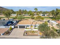 Beautiful single-story home featuring a well-manicured front yard and proximity to a lush green golf course at 544 W Thunderbird Rd, Phoenix, AZ 85023