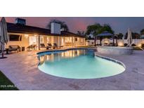 Beautiful backyard pool area with ample lounge space, a covered patio, and a luxurious gazebo, perfect for outdoor relaxation at 5975 E Larkspur Dr, Scottsdale, AZ 85254