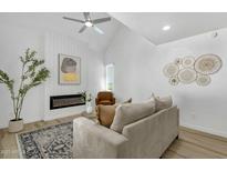 Bright living room features vaulted ceiling, modern fireplace and stylish decor at 6009 N 79Th St, Scottsdale, AZ 85250