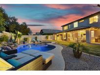 An inviting backyard oasis featuring a sparkling pool and lounge chairs on a lovely property at 7354 E Norwood St, Mesa, AZ 85207