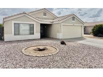 Charming single-story home with a low maintenance desert landscape and attached two-car garage at 1005 W 19Th Ave, Apache Junction, AZ 85120