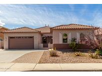 Charming single-story home featuring a well-maintained front yard and a two-car garage at 1123 E Buckingham Ave, Gilbert, AZ 85297