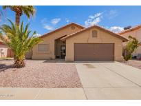 Charming single-story home features a low maintenance front yard and attached two-car garage at 15645 W Hilton Ave, Goodyear, AZ 85338
