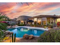 Inviting backyard oasis with a sparkling pool, spa, mature landscaping, and scenic views at 16670 N 109Th Way, Scottsdale, AZ 85255