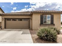 Charming single-story home featuring a tile roof, two-car garage, and neat desert landscaping at 20941 E Pecan Ln, Queen Creek, AZ 85142