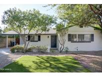 Charming home with well-maintained lawn, mature trees and white painted brick at 2533 E Flower St, Phoenix, AZ 85016