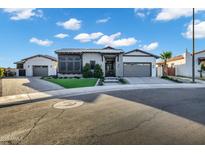Charming single-story home featuring manicured landscaping, a metal roof, and a welcoming driveway at 3842 E Alameda Ln, Gilbert, AZ 85298