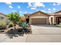 Charming single-story home with a well-manicured desert landscape and a two-car garage at 40055 N High Noon Way, Anthem, AZ 85086