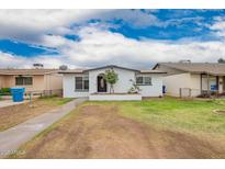 Charming single-story home with a well-maintained front yard and inviting curb appeal at 4213 W Medlock Dr, Phoenix, AZ 85019