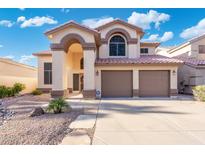 Inviting two-story home featuring a terracotta roof and a spacious two-car garage at 4446 E Woodridge Dr, Phoenix, AZ 85032