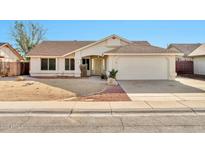 Charming single-story home featuring a two-car garage and a low maintenance desert landscaped front yard at 5029 N 86Th Dr, Glendale, AZ 85305
