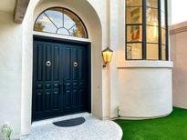 Elegant entryway featuring double doors, arched window, and a well-lit, inviting entrance at 10113 E Topaz Dr, Scottsdale, AZ 85258