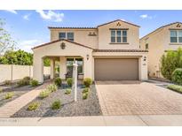 Charming two-story home featuring a welcoming front porch, desert landscaping, and a two-car garage at 10425 E Corbin Ave, Mesa, AZ 85212