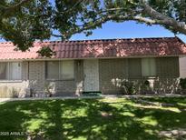 Charming single-story home with a red tile roof, well-maintained lawn, and mature shade trees in a desirable neighborhood at 141 N Date -- # 7, Mesa, AZ 85201