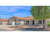 Inviting single-story home with a tile roof and landscaped front yard at 1617 E Fremont Rd, Phoenix, AZ 85042