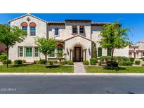 Charming two-story home featuring a tiled roof, arched entry, and landscaped front yard in a desirable neighborhood at 1930 W Yellowstone Way, Chandler, AZ 85248