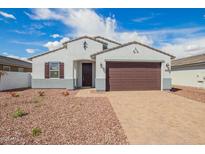 Charming single-story home with a two-car garage, paver driveway, and low-maintenance desert landscaping at 24356 W La Salle St, Buckeye, AZ 85326