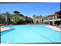 Stunning pool surrounded by palm trees, lounge chairs, and umbrellas at 5350 E Deer Valley Dr # 2435, Phoenix, AZ 85054