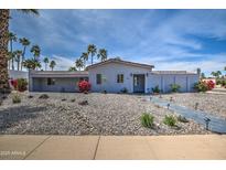 Charming single-story home featuring a desert landscape, palm trees and a tile roof at 6801 E Sheena Dr, Scottsdale, AZ 85254