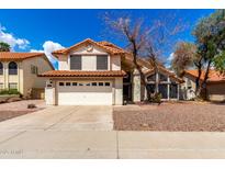 Charming two-story home featuring a tile roof, two-car garage, and desert landscaping at 7402 W Kerry Way, Glendale, AZ 85308