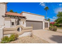 Charming home with a two-car garage, desert landscaping, and a unique architectural design at 7467 E Pleasant Run, Scottsdale, AZ 85258