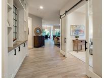 Inviting hallway showcasing hardwood floors, custom built-ins, and an open floor plan at 7979 E Princess Dr # 26, Scottsdale, AZ 85255