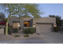 Charming single-story home featuring a well-manicured desert landscape and a two-car garage at 8235 E Sierra Pinta Dr, Scottsdale, AZ 85255
