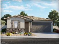 Charming single-story home featuring stone accents, a two-car garage, and desert landscaping at 8577 W Trenton Ct, Florence, AZ 85132