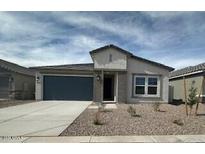 Charming single-story home featuring a two-car garage, neutral color palette, and low-maintenance front yard landscaping at 36956 W Santa Maria St, Maricopa, AZ 85138