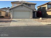 A two story stucco house with a two car garage, small front yard, and concrete driveway at 11918 W Aster Dr, El Mirage, AZ 85335