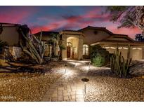 Exterior elevation showing a landscaped front yard with accent lighting and an attached two-car garage at 1502 W Wagner Dr, Gilbert, AZ 85233