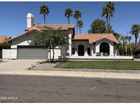 Charming single-Gathering home featuring a desert landscape, tile roof, and a private front patio for relaxing at 10266 E Caron St, Scottsdale, AZ 85258