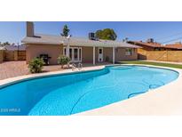 Refreshing backyard pool surrounded by a patio, perfect for summer relaxation and entertaining guests at 8129 N 17Th Dr, Phoenix, AZ 85021
