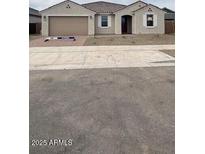 Charming single-story home with desert landscaping, a two-car garage, and a welcoming entrance at 14742 W Lariat Trl, Surprise, AZ 85387