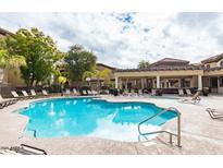 Resort-style pool area with lounge chairs, covered pavilion, and lush landscaping at 10136 E Southern Ave # 2048, Mesa, AZ 85209