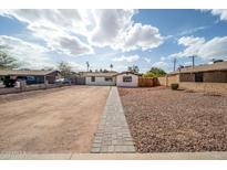 Charming single-story home with an expansive gravel front yard and gray paver pathway under a bright sunny sky at 1108 N Esther St, Tempe, AZ 85288
