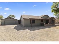 Charming single-story home with a well-maintained yard, garage, and inviting facade at 232 W San Angelo St, Gilbert, AZ 85233