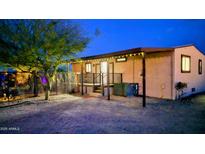 Inviting home exterior featuring porch with black railing, lighted entryway and desert landscaping at 29972 N Bryce Trl, San Tan Valley, AZ 85144