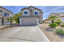 Two-story home featuring neutral stucco, a two-car garage, and a well-maintained desert landscape at 515 S Apache Dr, Chandler, AZ 85224